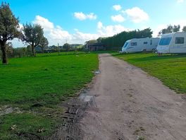 Main path to pitches. hard standings need to extend to path edge to avoid churning grass up