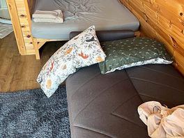 Sofa bed laid out with pillows for size comparison
