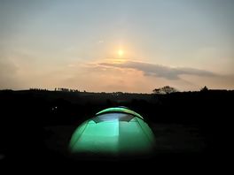 Our tent glowing below the moonlight.