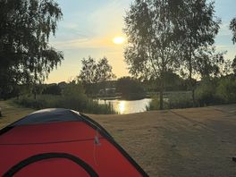 Tent by side of pond