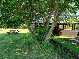 Picnic bench which is opposite the outdoor kitchen