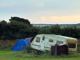 Abandoned looking caravan in the middle of the field