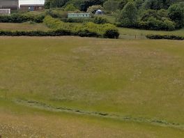 View of the farmhouse, buildings & pitches before entering the woods to get to the beach