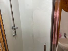 Private shower in the room with toilet & sink