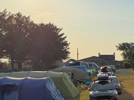 Tents very close together, barely enough space to park your car.