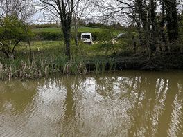 View of the pitch from other side of the river