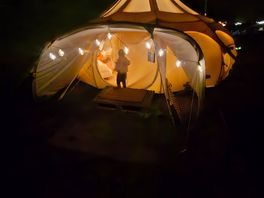 Schlamping pods all lit up at night