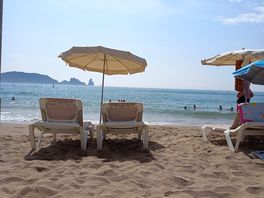 Parasols and loungers are available to hire.