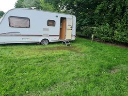 Muddy pitch thatvwwas flooded in awning