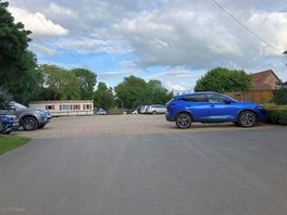 Car park with campsite at far end
