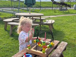 Enjoying the toys while waiting for breakfast