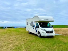 A motorhome pitched on the lower field, short walk to the sea!