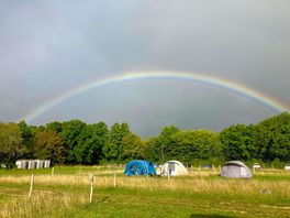 Rainbow over the washing facilities and tent camping