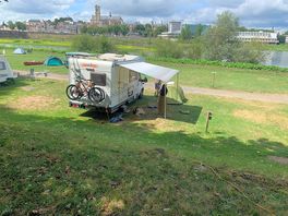 View of pitch with river and town behind.