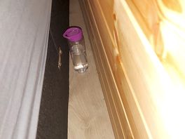 Previous occupants water bottle that had been wedged in between bed and wall