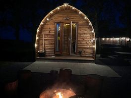 The log cabin with pretty lights whilst having a fire
