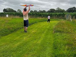 Attempting to fly a kite.