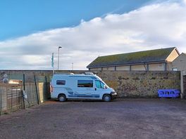 My van tucked in the corner out of the elements