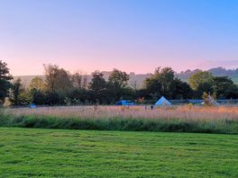 Sunset from our pitch with the kids playing amongst the wildflowers in the meadow