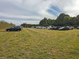 The campsite/carpark. toilet and shower can be seen at the far end of the field.