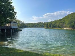 Swimming lake with beach and paddleboards and kayaks for hire