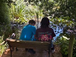 Boys enjoying the serenity of the pond