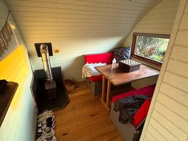 Second seating area with table that converts into a double bed and a log burning fire