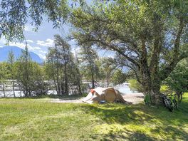 Pitch between the river and trees