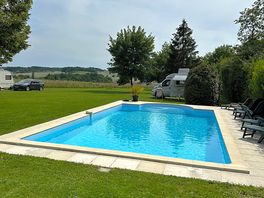 A view of the pool and part of the site showing the views in the distance.