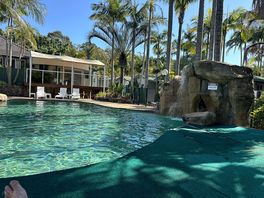 By the waterfall in the pool
