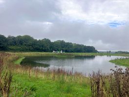 View across large pond to the main camping area