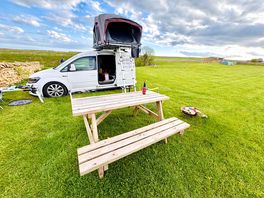Clean camping pitch with picnic tables available