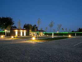 Night view of Camping Palić - well-lit serviced pitches with electricity, water and young trees.