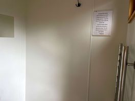 Area in shower room for clothes and towels