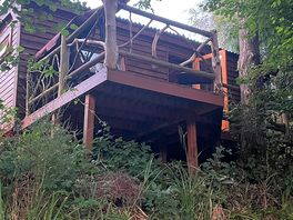 Accommodation is more like a tree house than a shepherds hut from this side. overlooking lake.