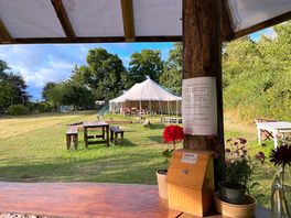 View from the kitchen towards open and covered seating / dining areas.