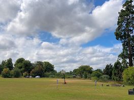 Lovely big field with badminton and basketball net and box of communal outdoor toys.