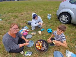 Family around the campfire cooking
