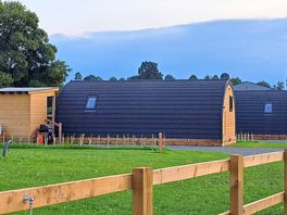 Huge camping pods with hot tubs.