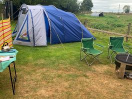 Electric pitch with our tent and a goat named domino just out of shot who loves to see what’s what.