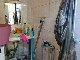 Disabled bathroom full of cleaning equipment, shower completely buried. no attempt to clear it