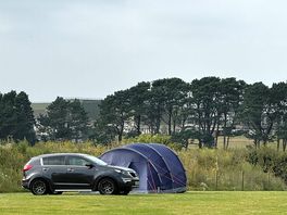 Tent with car at bottom of the site