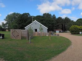 Toilet/shower block central to site.