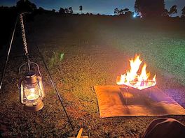 Outdoor fire and lamp on an autumn evening
