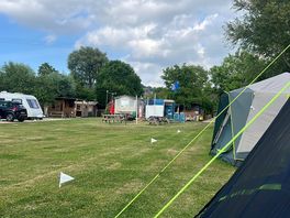 View from pitch toward showers, toilets, benches