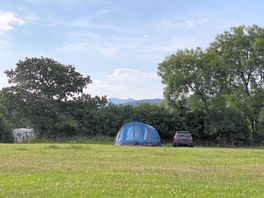 Non electric grass pitch with Yr Wyddfa in the background. Gwair heb drydan gyda'r Wyddfa yn y cefnd