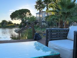 View of natural pool at sunset from pool bar.