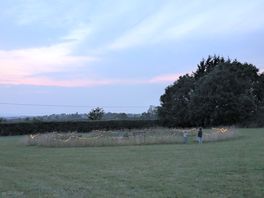 The middle area with large fire pit and benches which lights up with fairy lights at night