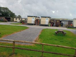 Camping site in front of caravan.