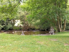 By the river.